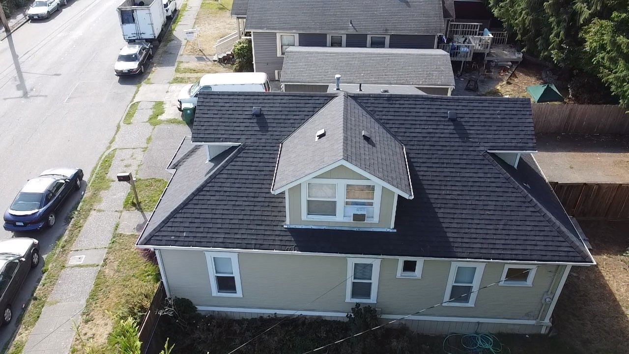 Residential Roof Shingles before picture from another angle. Old worn out black roof.