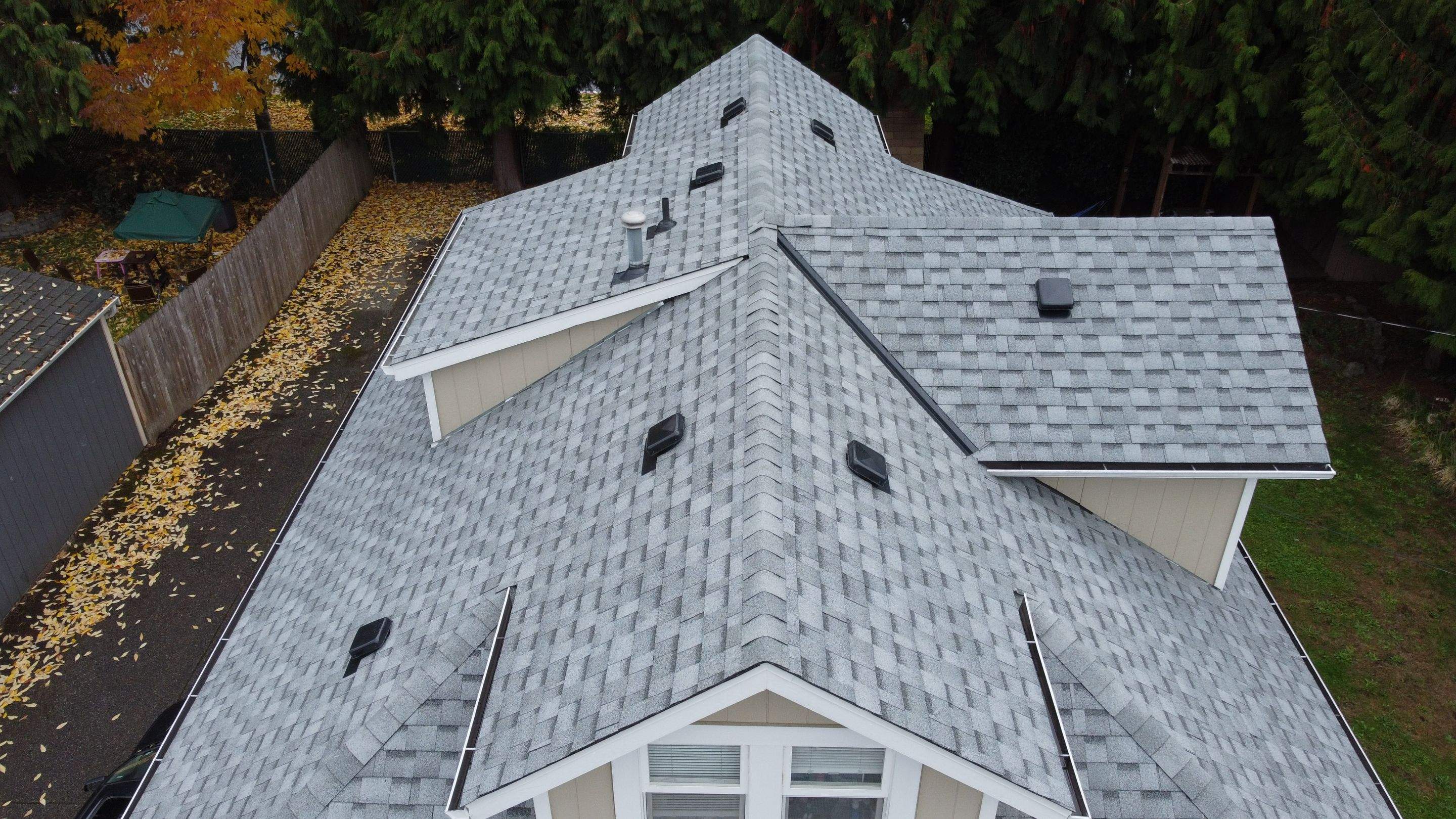 New Residential Roof with white shingles taken from a drone. The Benefits of Energy-Efficient Impact of roofing materials