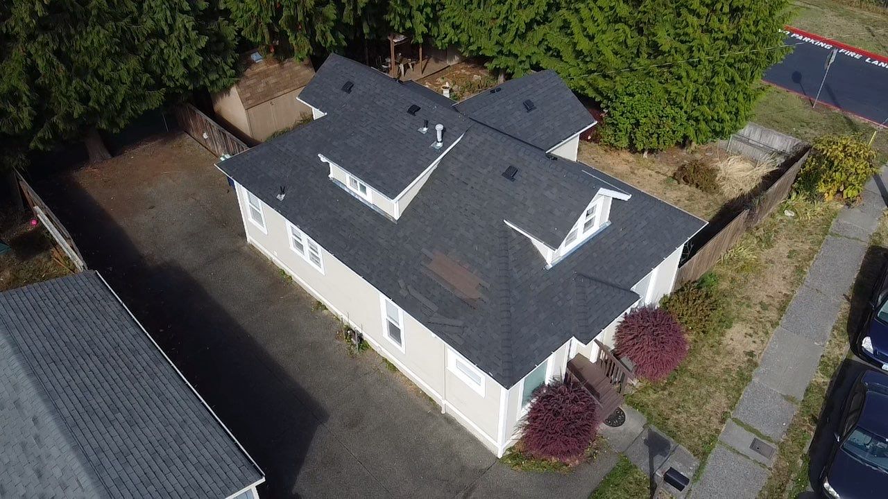 Shingles roof replacement before. It has blown off shingles and is a black worn out roof. Prevent and Deal with Roof Leaks in Washington's Rainy Season