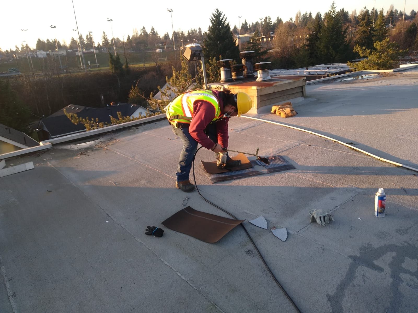Trade Roofing roofer appliyng a Roofing Repair on Flat Roof with Torch Down
