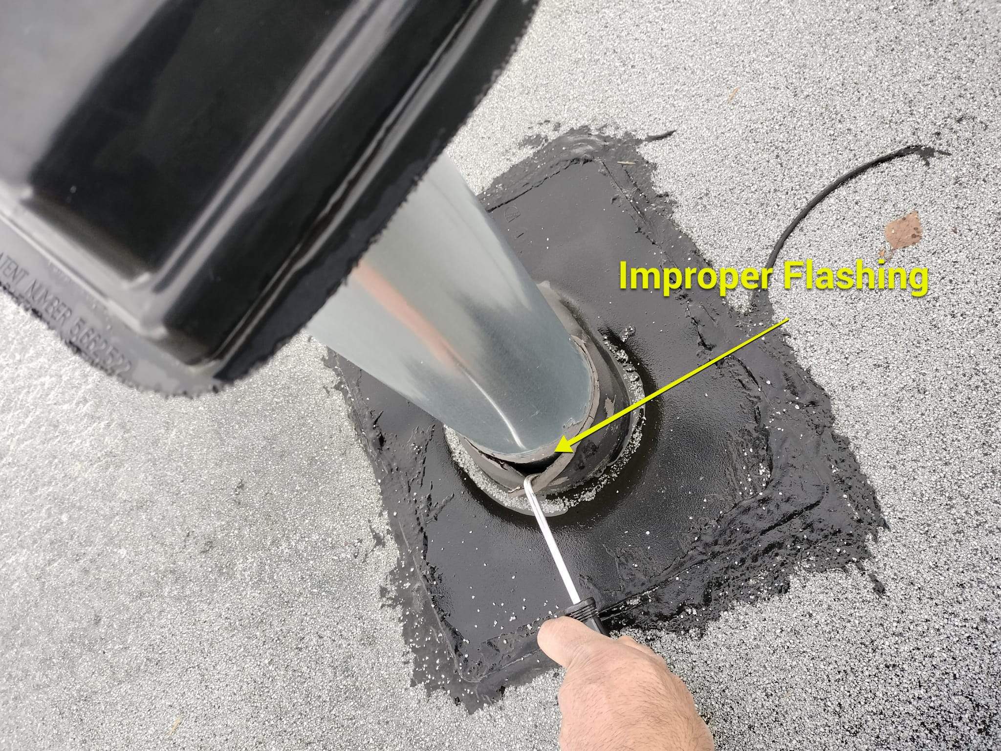 Picture of improper flashing at a penetration on a asphalt bitumen roof.