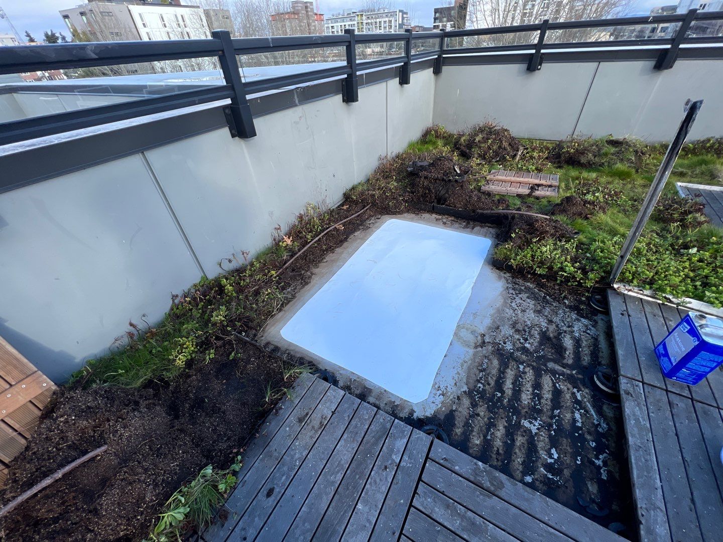 A team of skilled roofing technicians fixing a leak in a commercial building, ensuring a secure and weather-tight structure